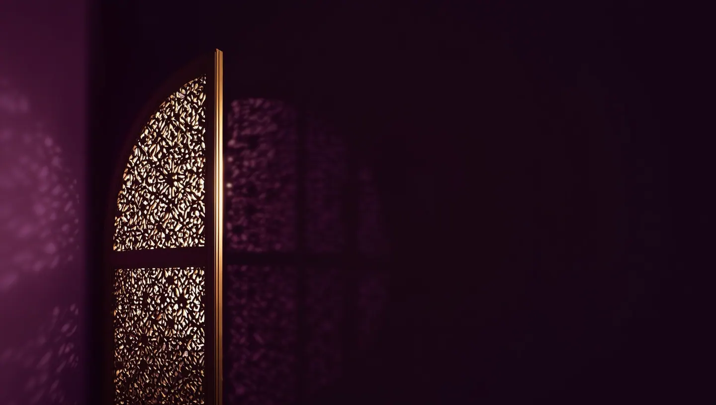A carved mashrabiya screen casting patterned light on a plum wall